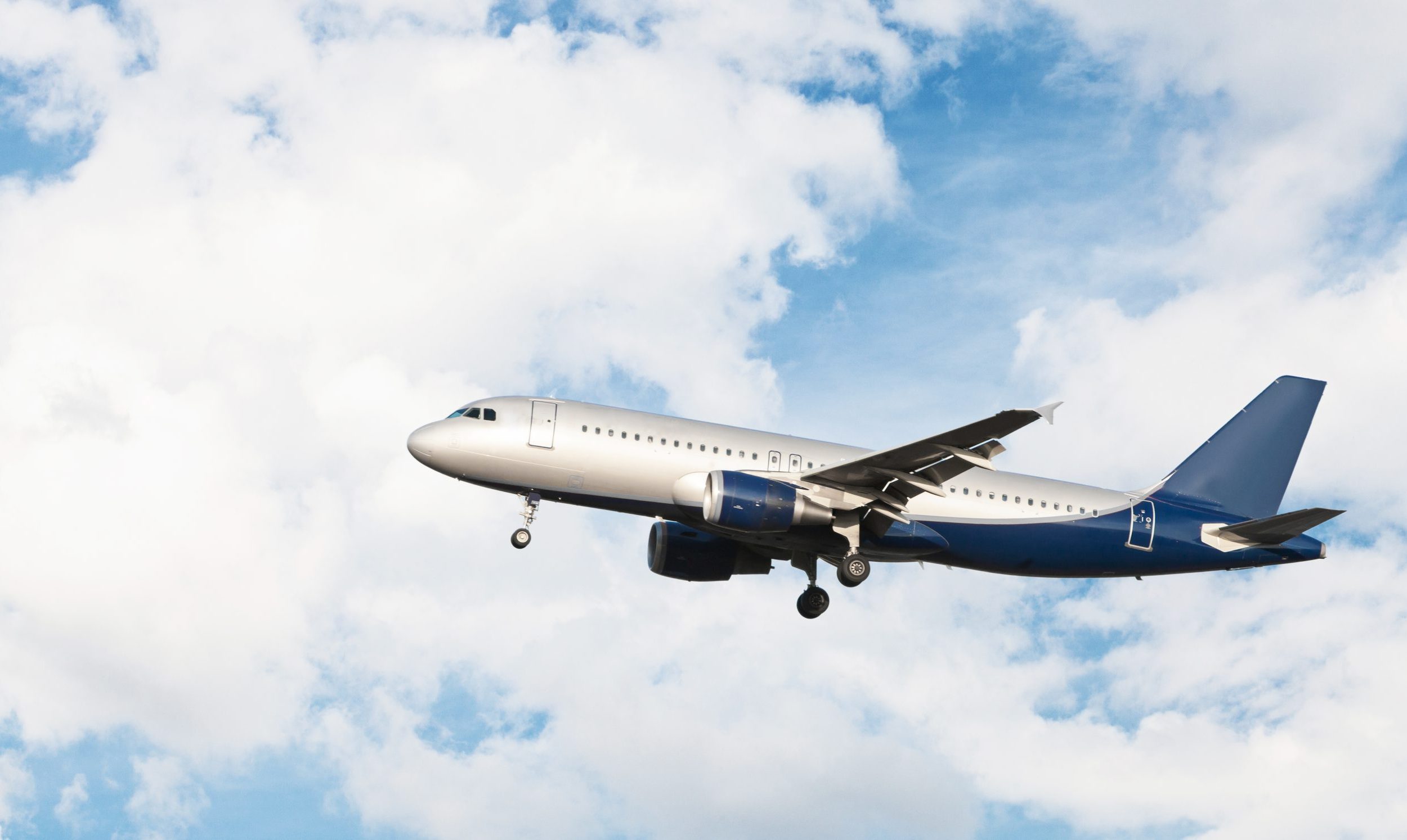 Modern airplane flying in a cloudy sky